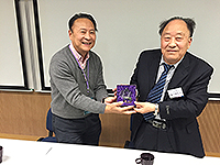 Prof. Lin Hui, Director of Institute of Space and Earth Information Science presented a souvenir to Prof. Wei Ziqin, Division of Information and Electronic Engineering